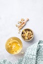 Chamomile herbal tea in a glass cup on a light background with dry flowers and napkin. The concept of a healthy detox drink for Royalty Free Stock Photo