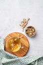 Chamomile herbal tea in a glass cup on a wooden board on a light background with dry flowers. The concept of a healthy detox drink Royalty Free Stock Photo