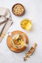 Chamomile herbal tea with lemon in a glass cup and teapot with flowers on a light background. The concept of a healthy drink for Royalty Free Stock Photo