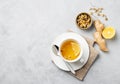 Chamomile herbal tea with lemon in a white cup on a light background with dry flowers and ginger. The concept of a healthy detox Royalty Free Stock Photo