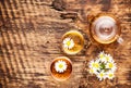 Chamomile herbal tea in a teapot and cup and chamomile flowers on a wooden table Royalty Free Stock Photo