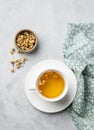 Chamomile herbal tea in a white cup on a light background with dry flowers. The concept of a healthy detox drink for health and Royalty Free Stock Photo