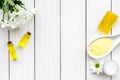 Chamomile spa cosmetics with natural herbal ingredients. Chamomile spa salt, soap, oil and cream on white wooden Royalty Free Stock Photo