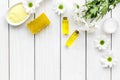 Chamomile spa cosmetics with natural herbal ingredients. Chamomile spa salt, soap, oil and cream on white wooden Royalty Free Stock Photo