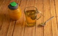 Chamomile tea, with chamomile flowers, in a clear glass cup with a metal tea diffuser, one side honey bee container to sweeten Royalty Free Stock Photo