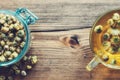 Chamomile tea cup and glass jar of dry daisy flowers. Top view. Royalty Free Stock Photo