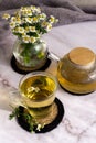 Chamomile tea. Herbal tea. Glass cup with warm fragrant chamomile tea