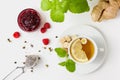 Chamomile tea with mint, raspberry jam and ginger on white background Royalty Free Stock Photo