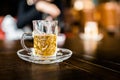 Chamomile tea welcome drinks served in small drinking glass with blur background. Herb drinks