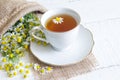 Chamomile tea on white wooden background Royalty Free Stock Photo