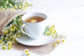 Chamomile tea on white wooden background Royalty Free Stock Photo