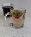 Chamomile teabag in glass mug on table Royalty Free Stock Photo