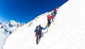 CHAMONIX, FRANCE - MARCH 19, 2016: a group of mountaineer climb a snowy peak. In background the glaciers and the summit of Mont Bl Royalty Free Stock Photo