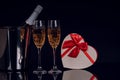 Champagne bottle in bucket with two wine glasses and gift box Royalty Free Stock Photo