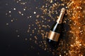 Champagne bottle with confetti stars, holiday decoration and party streamers on gold festive background Royalty Free Stock Photo