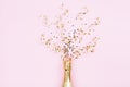 Champagne bottle with confetti stars and party streamers on pink background. Christmas, birthday or wedding concept. Flat lay. Royalty Free Stock Photo