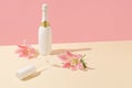 Champagne bottle and glass with pink flowers on a beige background. Minimal Valentine`s Day or Woman`s day layout. Nature party