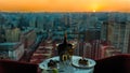 Champagne bottle and glasses, cake at restaurant with sunset