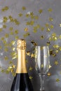 Champagne bottle and glasses with gold confetti stars. Concept for christmas, birthday or wedding Royalty Free Stock Photo