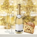 Champagne bottle with glasses and panettone slice