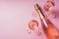 Champagne bottle with glasses on pastel background. Party background with sparkling wine, bubbling rose champagne, celebration Royalty Free Stock Photo