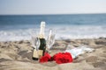 Champagne Bottle, Glasses, Roses at the beach