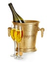 Champagne bottle in golden ice bucket with glasses of champagne close-up on a white background. Festive still life. Royalty Free Stock Photo