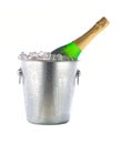 Champagne bottle in ice bucket isolated on white background over white background Royalty Free Stock Photo
