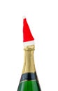 champagne bottle with red santa cap. Red santa claus hat on champagne bottle isolated on white Royalty Free Stock Photo