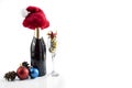 The champagne bottle with Santa hat and champagne glass with Christmas decorations Royalty Free Stock Photo