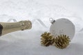 Champagne bottle in snow with christmas tree ball Royalty Free Stock Photo
