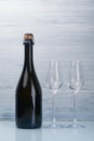 Champagne bottle and two empty glasses on a gray background Royalty Free Stock Photo