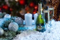 Champagne and Candles on Festive Snowy Surface