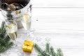Champagne for celebrate new year. Glasses, bottle in bucket, spruce branch on white wooden background copyspace Royalty Free Stock Photo