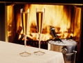 Champagne chilling by the fire Royalty Free Stock Photo