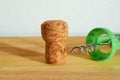 A champagne cork and a corkscrew are lying on a wooden table. Selective focus Royalty Free Stock Photo