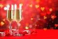 Champagne for couple in love in two flutes on table with red tablecloth Royalty Free Stock Photo