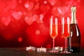 Champagne for couple in love in two flutes on table with red tablecloth Royalty Free Stock Photo