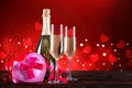 Champagne for couple in love in two flutes on table with red tablecloth Royalty Free Stock Photo