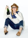 Champagne, drunk or relax with woman on floor in studio with hangover celebration, party or event. Pointing or female