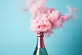Champagne explosion on blue background. Glass wine bottle with beautiful pink smoke for celebration Christmas or New Year. Royalty Free Stock Photo