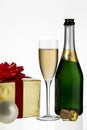 Champagne flute and bottle with christmas gift Royalty Free Stock Photo