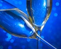 Champagne flutes on blue light bokeh background Royalty Free Stock Photo