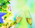 Champagne flutes with golden bubbles on christmas tree decoration background Royalty Free Stock Photo