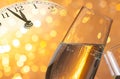 Champagne flutes with golden bubbles on golden light bokeh background Royalty Free Stock Photo