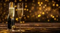 Champagne flutes with sparkling wine on a festive background. Elegant celebration setting with golden lights Royalty Free Stock Photo