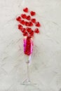 champagne glass with splash of red heart on white background. Valentine's Day concept Royalty Free Stock Photo