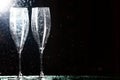 Champagne glasses on black spray