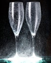 Champagne glasses on black spray Royalty Free Stock Photo