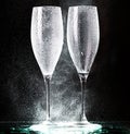 Champagne glasses on black spray Royalty Free Stock Photo